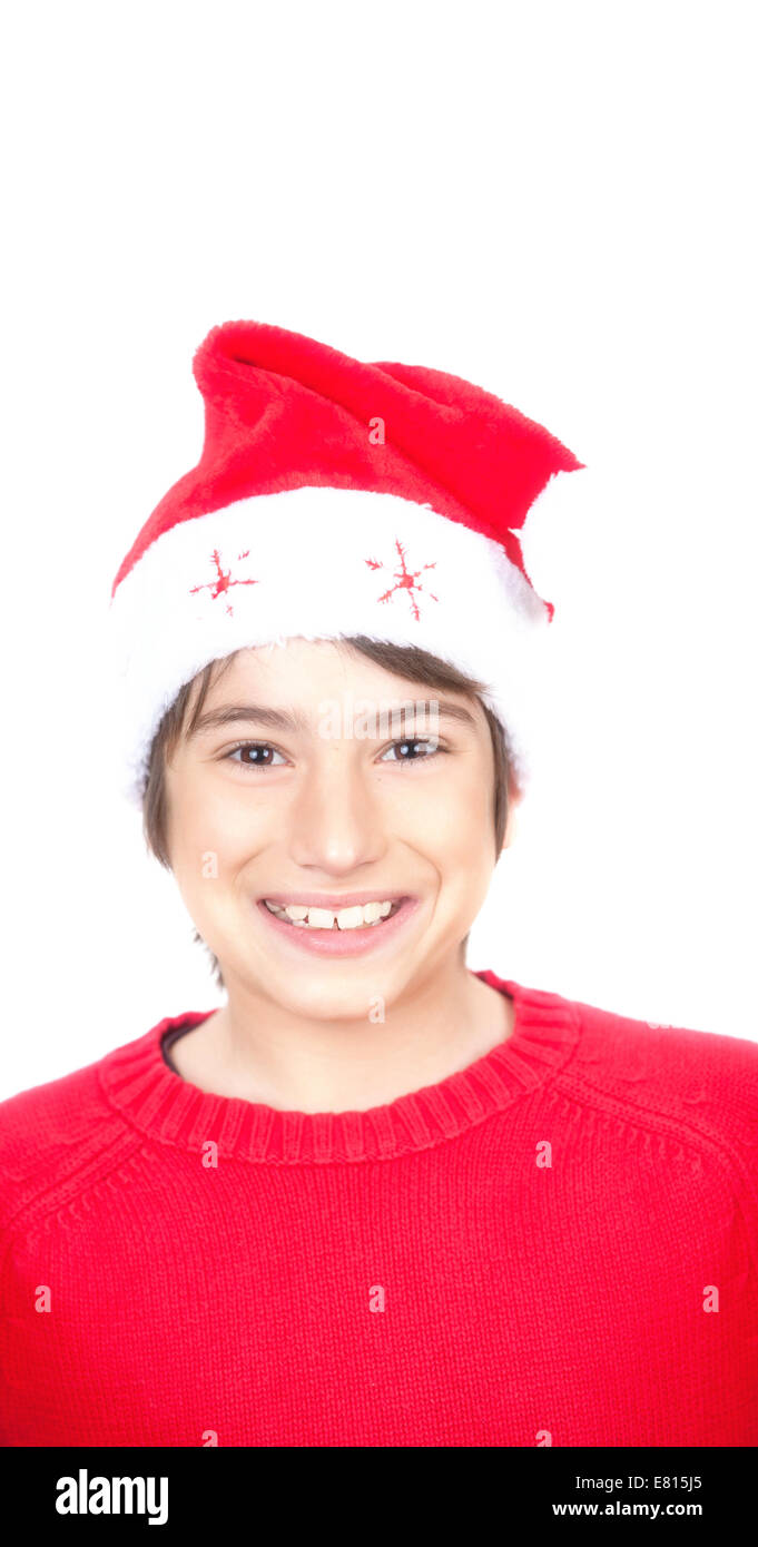 Happy smiling boy with red sweater and Christmas hat, isolated on white. Stock Photo