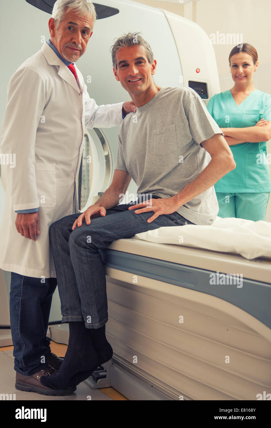 Happy male patient with doctors explaining ct scan test. Stock Photo