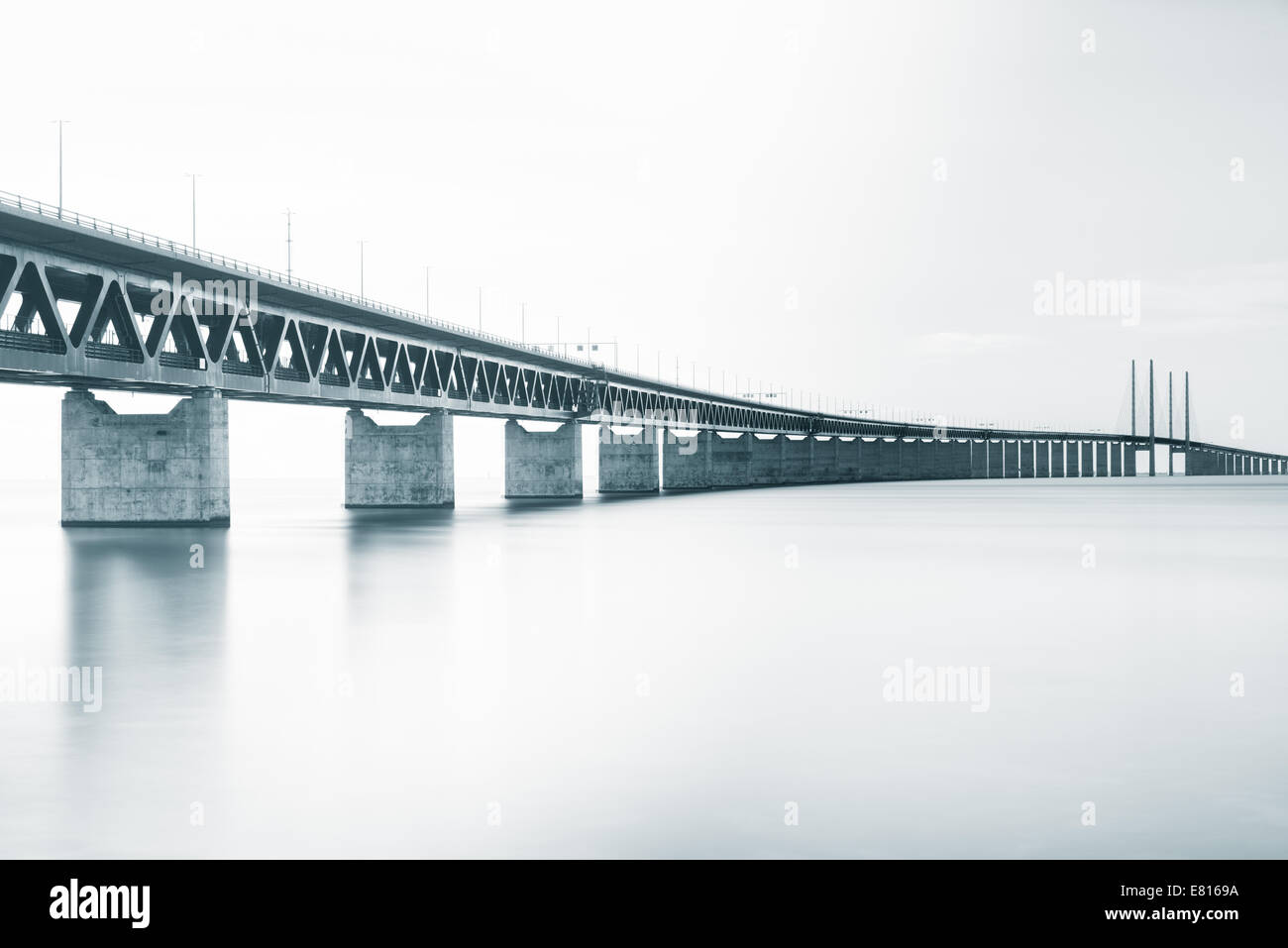 Long bridge over a river on a cloudy day Stock Photo