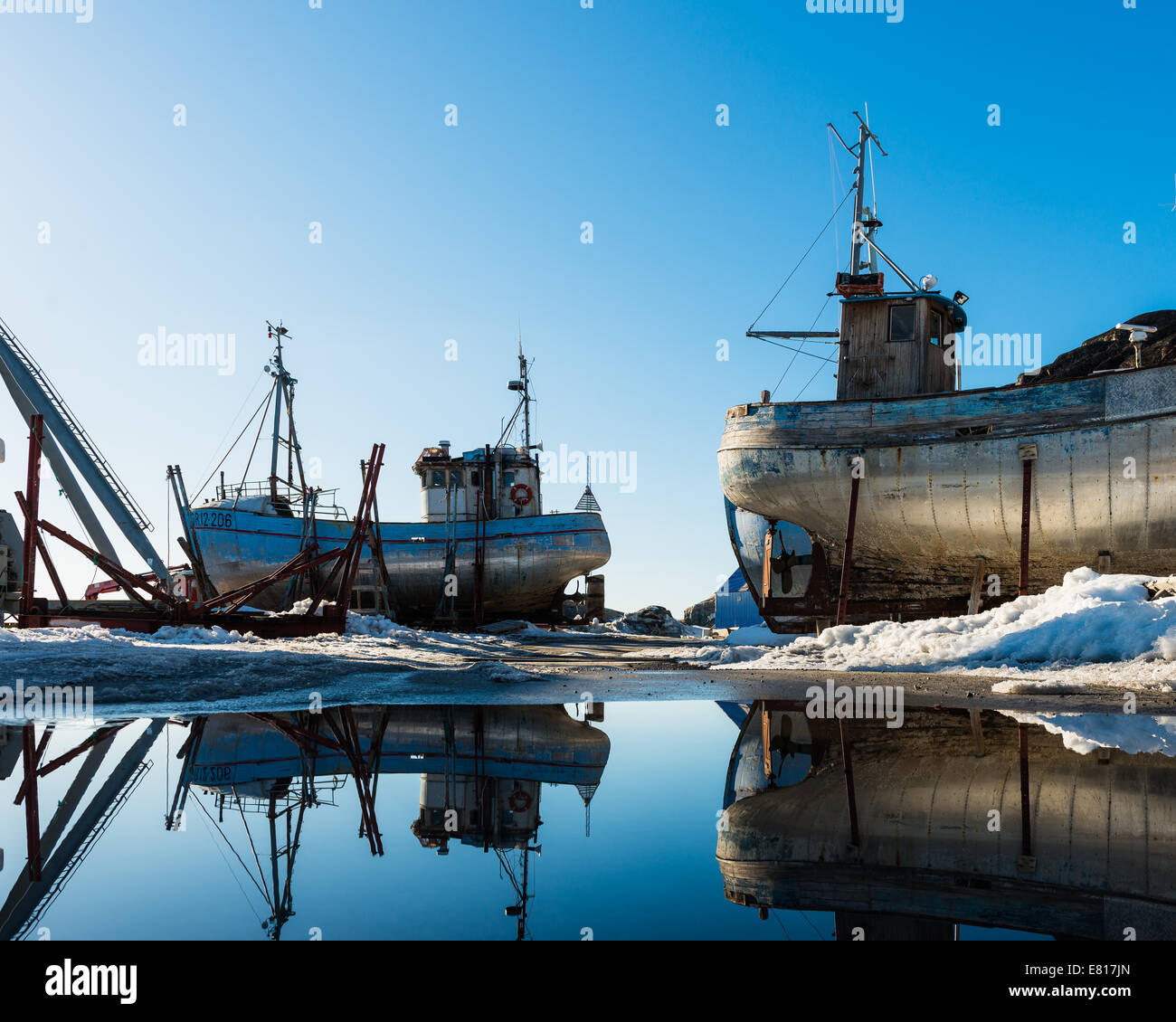 Boats beached on the snowy shore Stock Photo