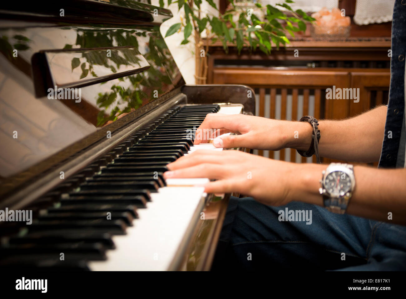 Male hands playing piano indoors inside house Stock Photo