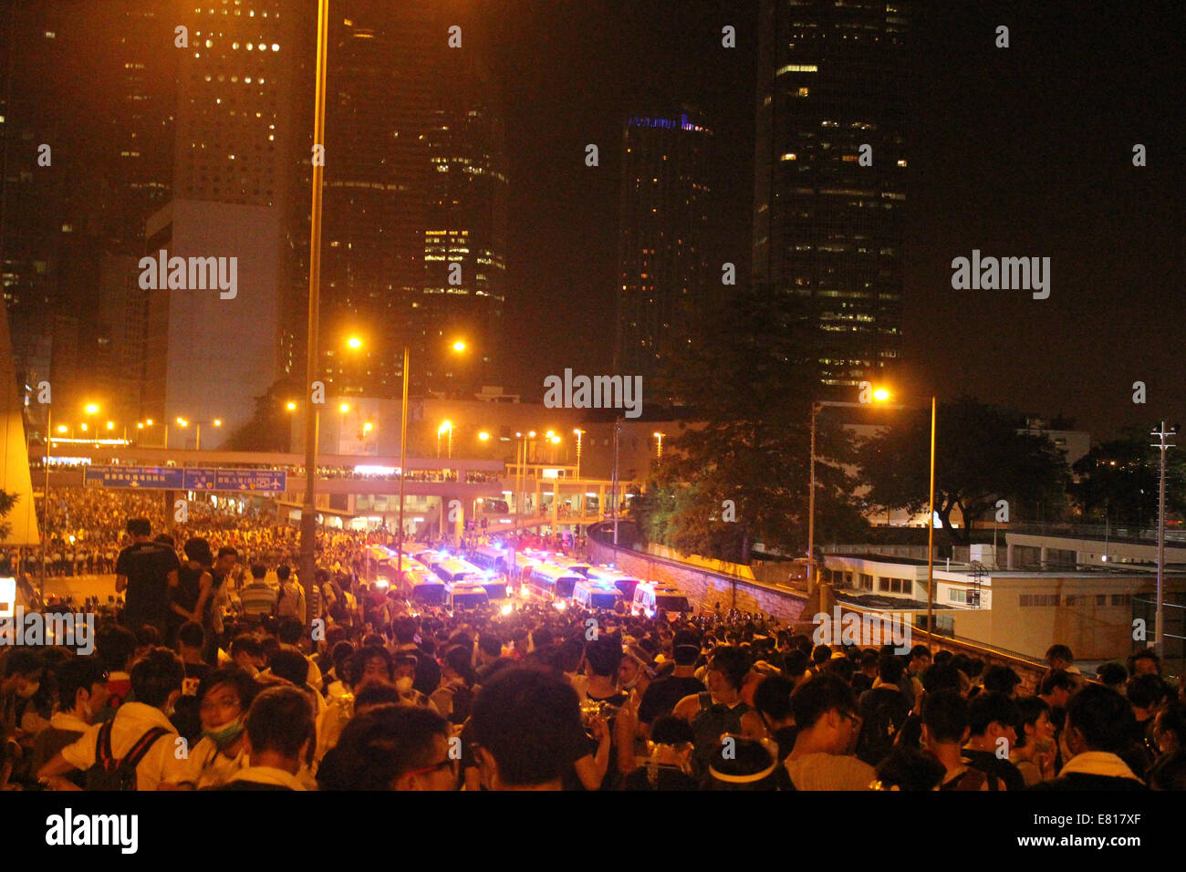 Hong Kong, 28 Sep, 2014. Hong Kong Protests: Harcourt Road, Central, a busy road in Hong Kong, is blocked as part of Occupy Central's pro-democracy civil disobedience campaign. Police vans with flashing lights stand behind police lines. Credit:  Robert SC Kemp/Alamy Live News Stock Photo