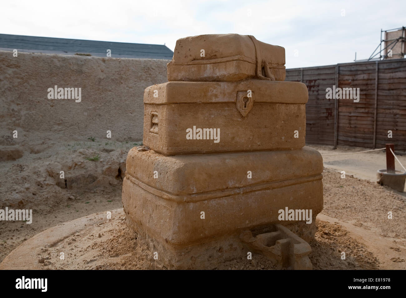 Going on holiday? three suitcases on display at the Sand Sculpture festival in Brighton Stock Photo
