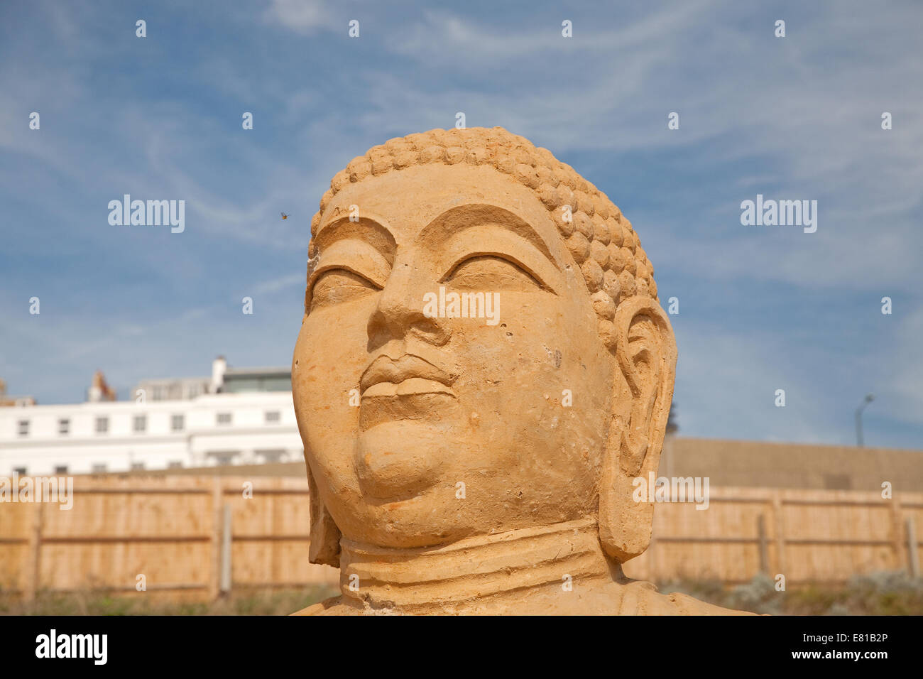 The head of the Tian Tan Buddha from China on display at the Sand Sculpture festival in Brighton Stock Photo