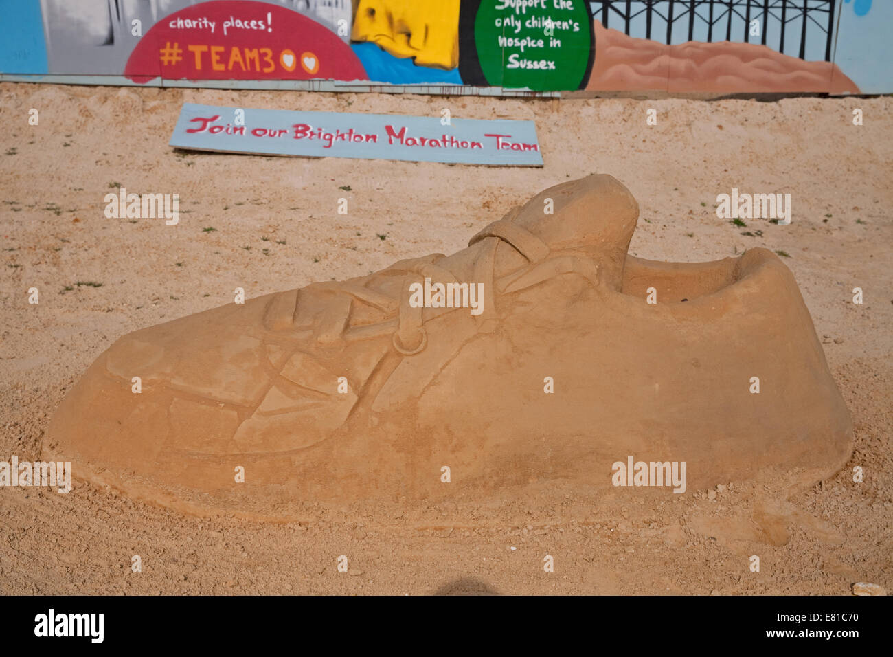 A training shoe on display at the Sand Sculpture festival in Brighton Stock Photo
