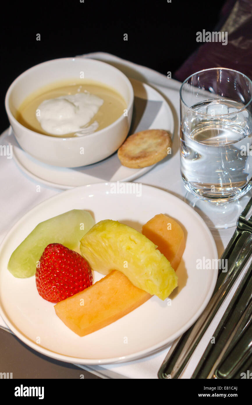 New York,New York,John F. Kennedy International Airport,JFK,onboard,American Airlines,class,plate,dish,food,fruit,pudding,glass,water,NY140305057 Stock Photo