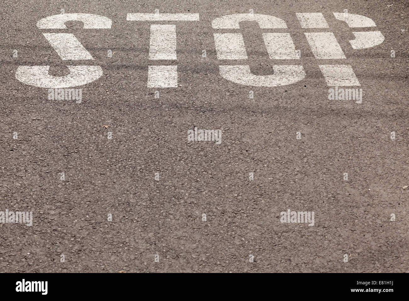 stop sign painted on asphalt Stock Photo