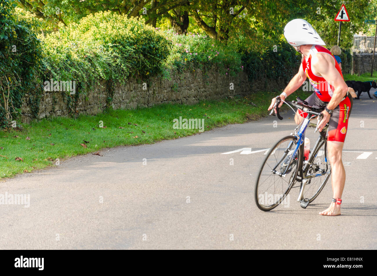 a cyclist looks back for his team member Stock Photo - Alamy