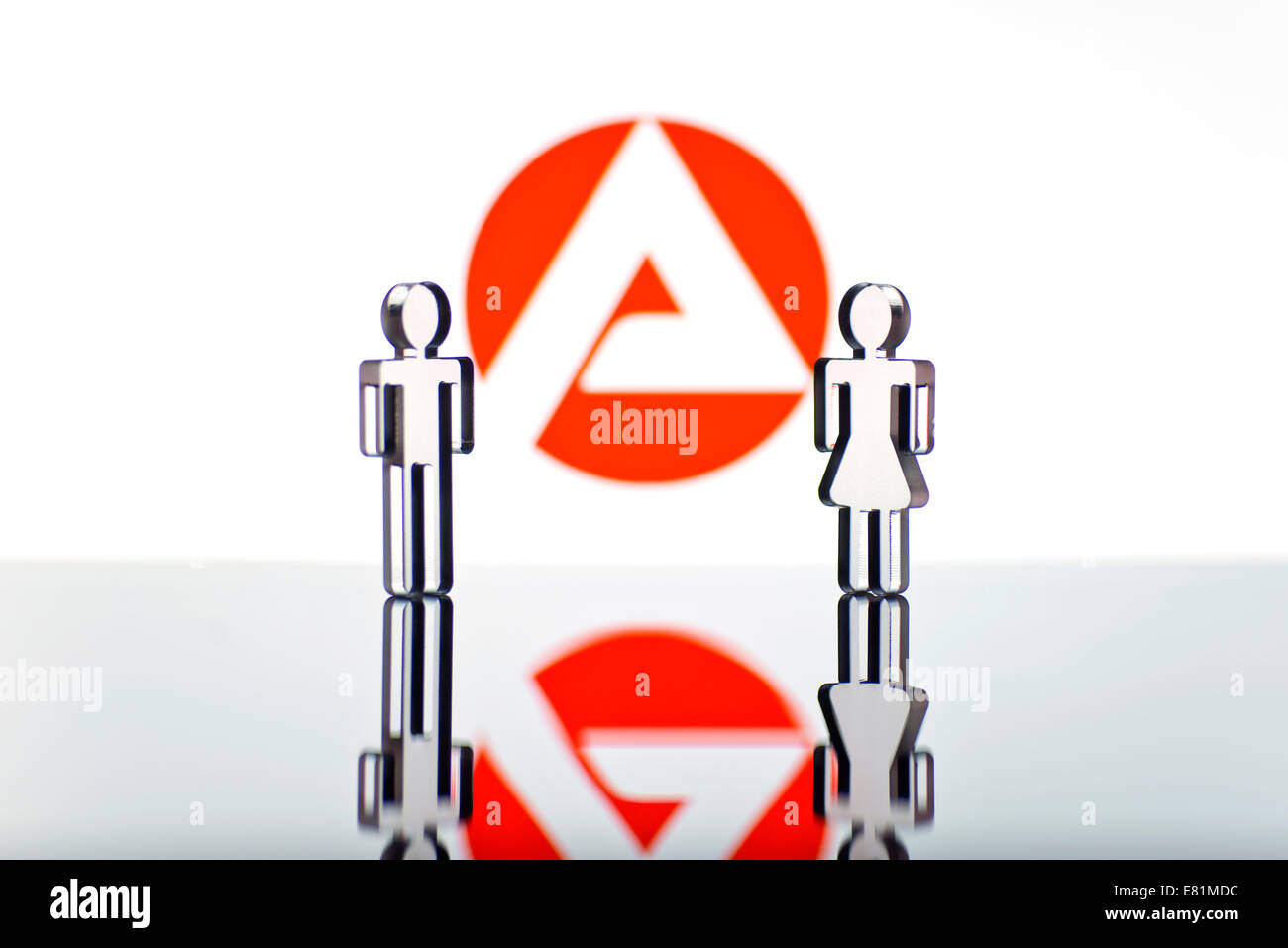Two figures standing in front of the logo of the German employment agency, symbolic picture for unemployment Stock Photo