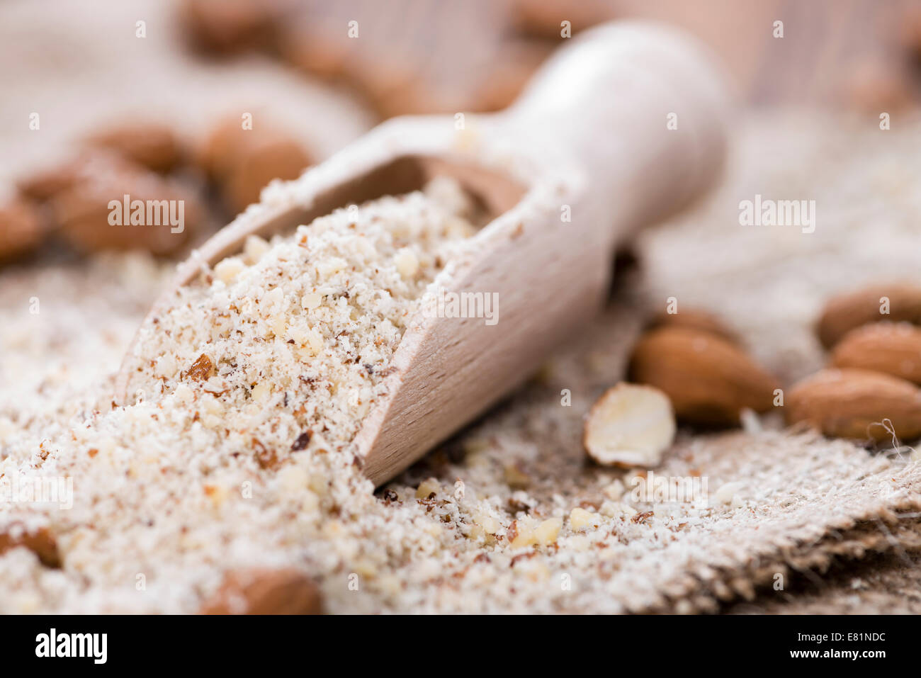 Portion of fresh grated Almonds on wooden background Stock Photo