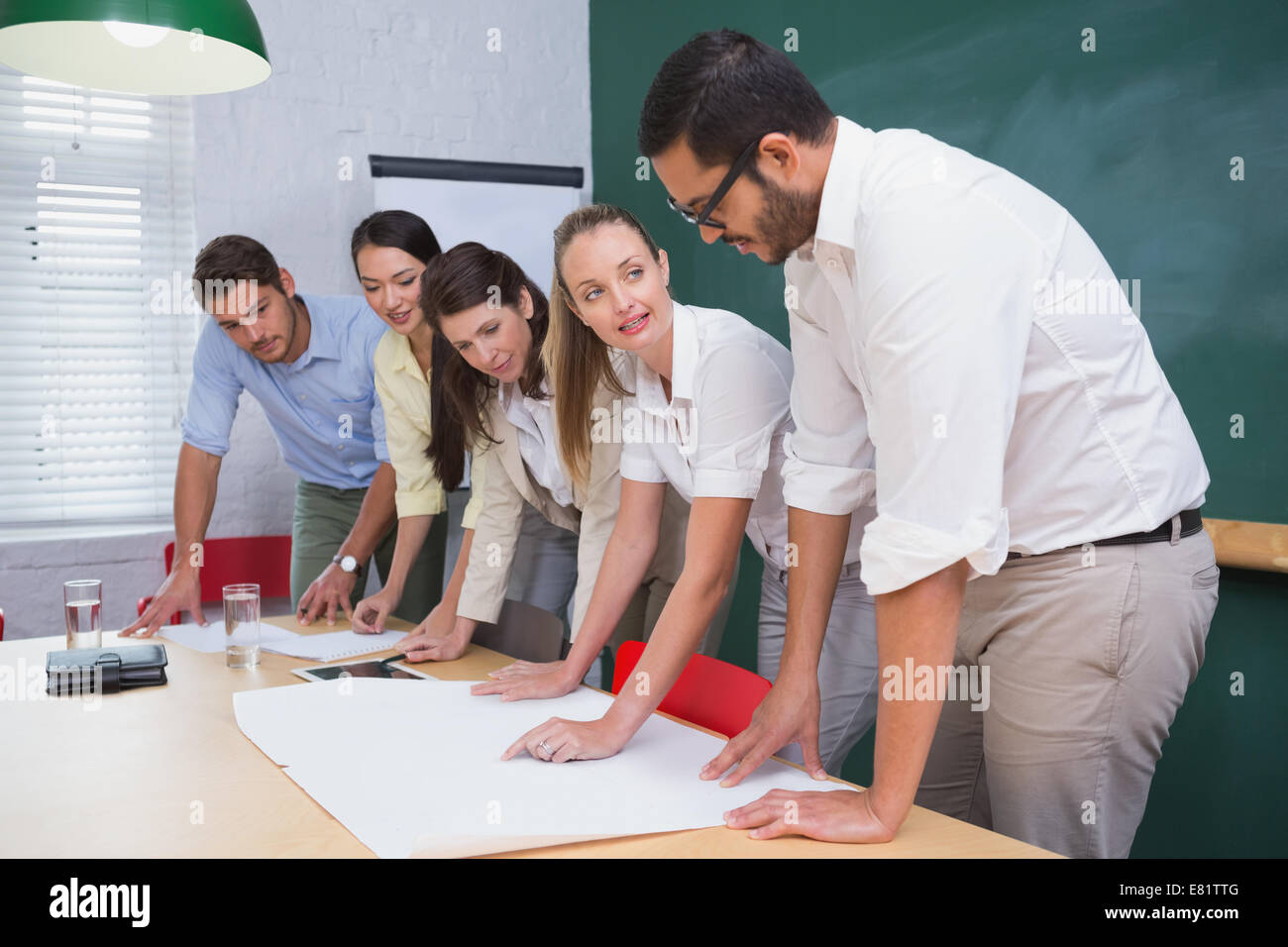 Team architects going over blueprints hi-res stock photography and ...