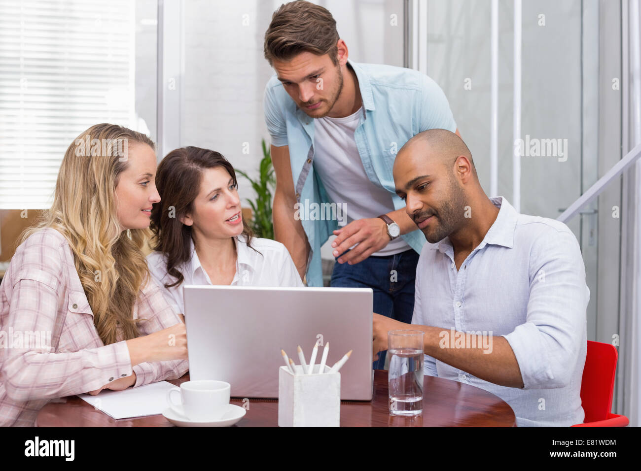 Business team working together with laptop Stock Photo - Alamy