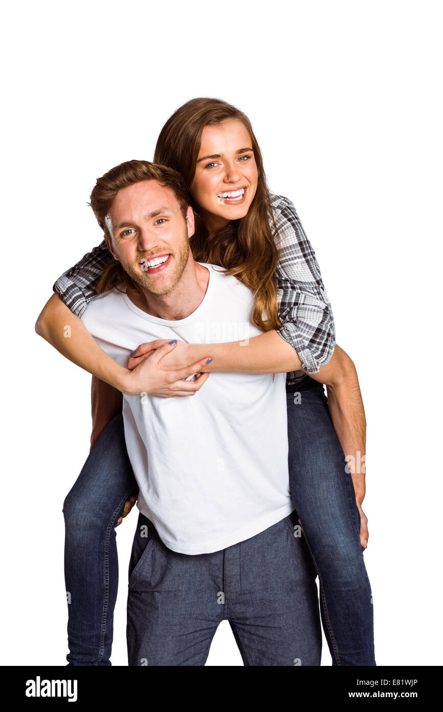 Smiling young man carrying woman Stock Photo
