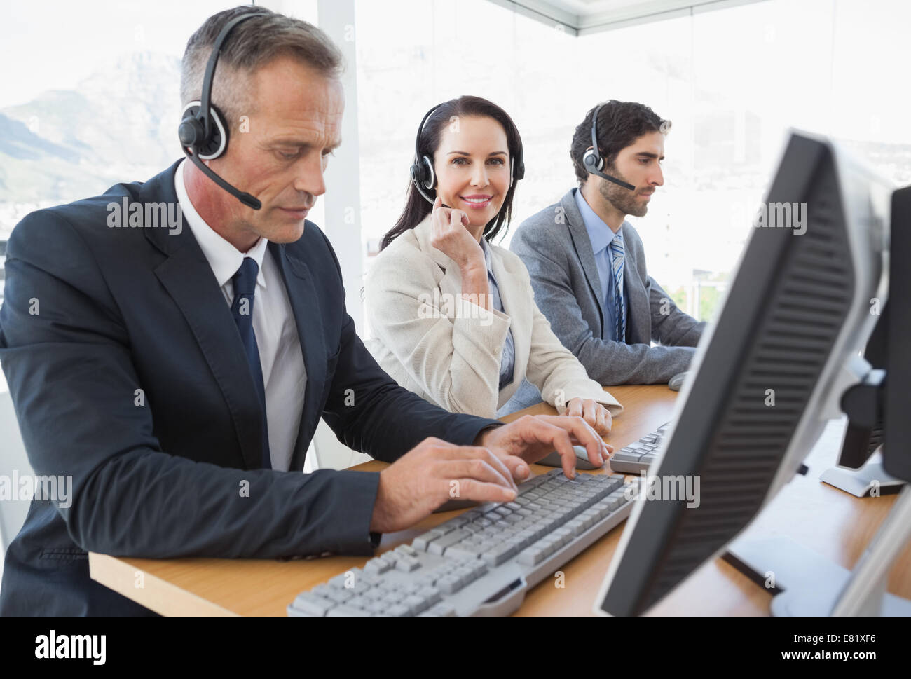 Smiling businesswoman working with teammates Stock Photo