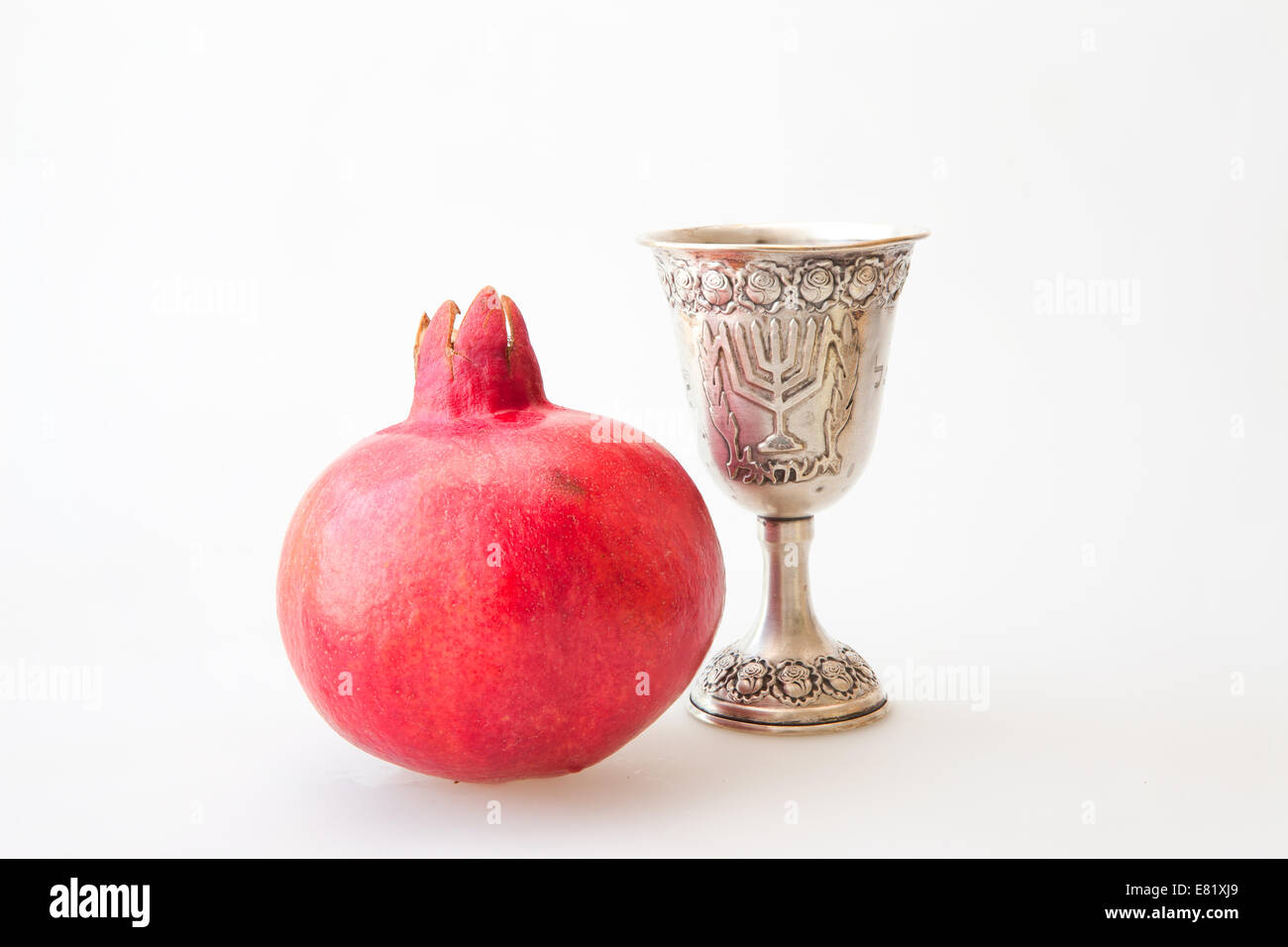 Rosh Hashanah Kiddush cup honey pomegranate and sliced apple Stock