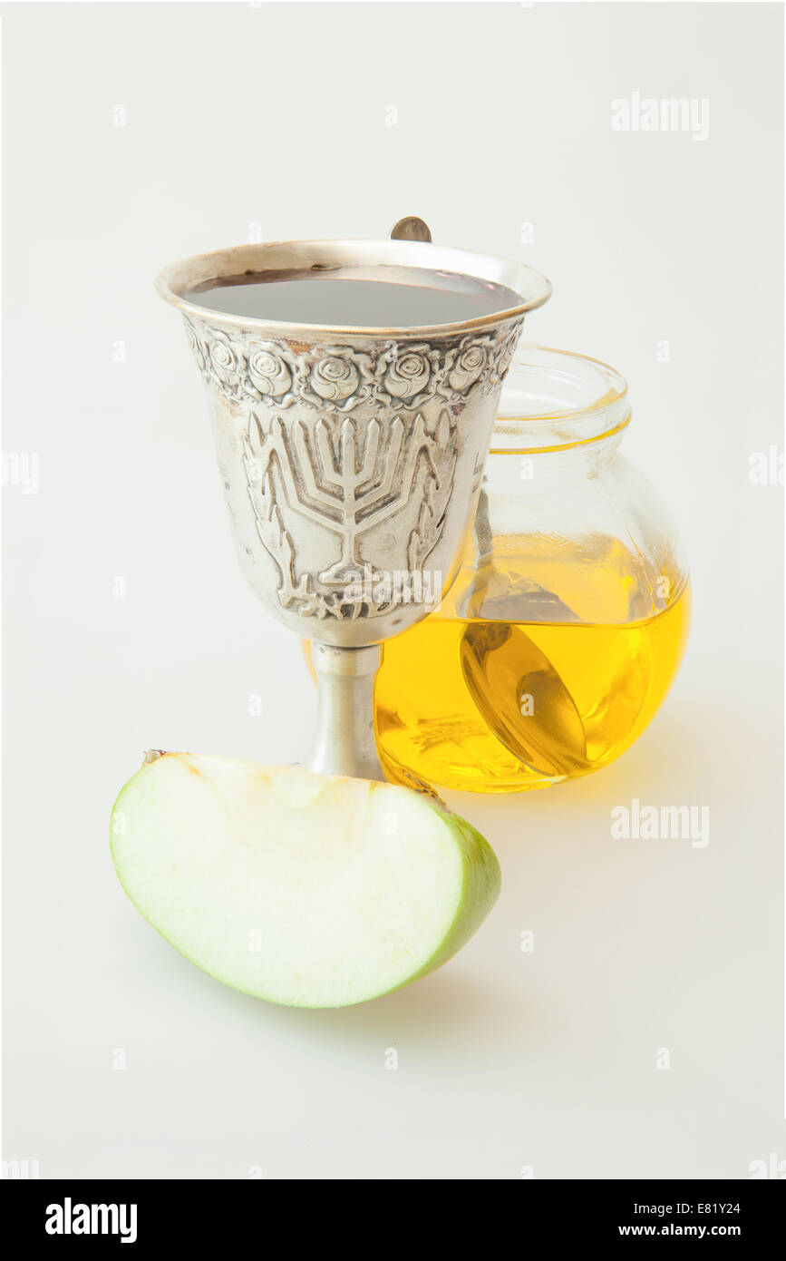 Rosh Hashanah Kiddush cup honey pomegranate and sliced apple Stock Photo