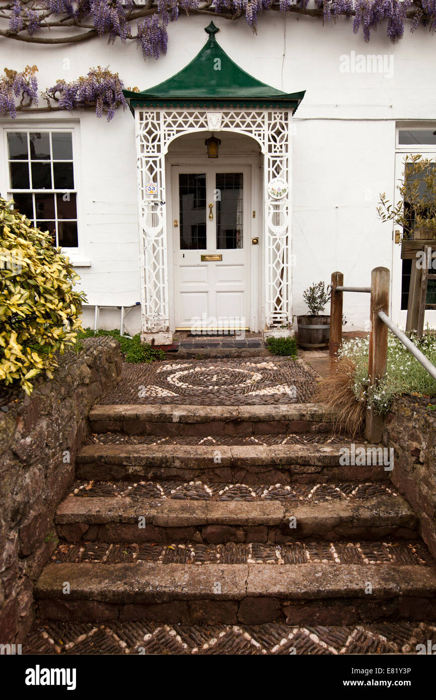 UK, England, Somerset, Nether Stowey, Castle Street, pebble cobbled path leading to ornate iron porch Stock Photo
