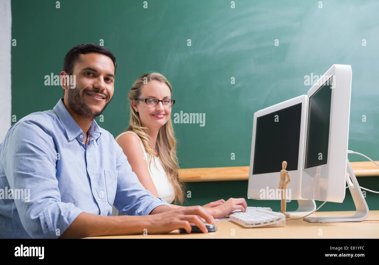 Colleague Computer Casual colleagues using computer at office Stock Photo - Alamy