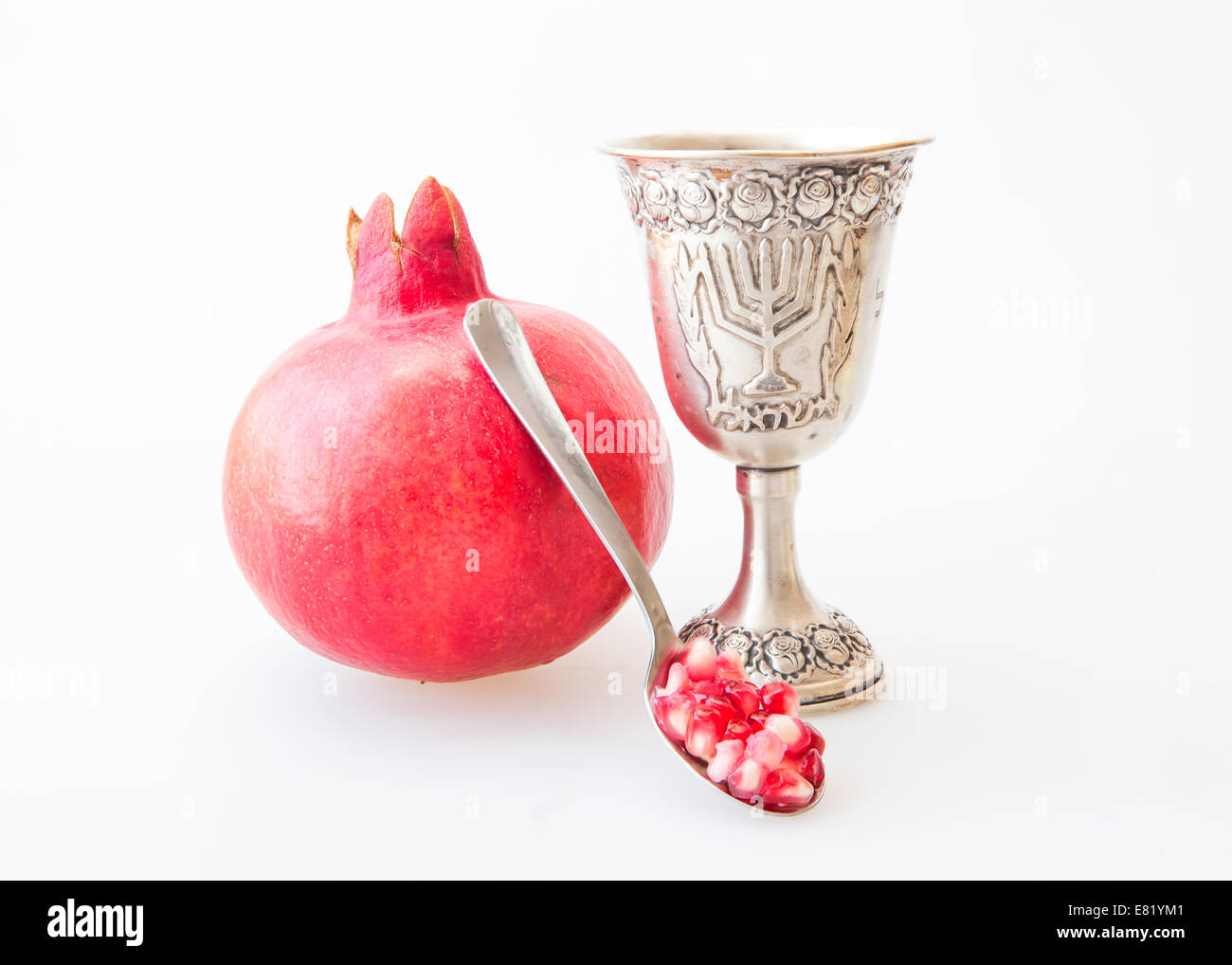 Rosh Hashanah Kiddush cup honey pomegranate and sliced apple Stock