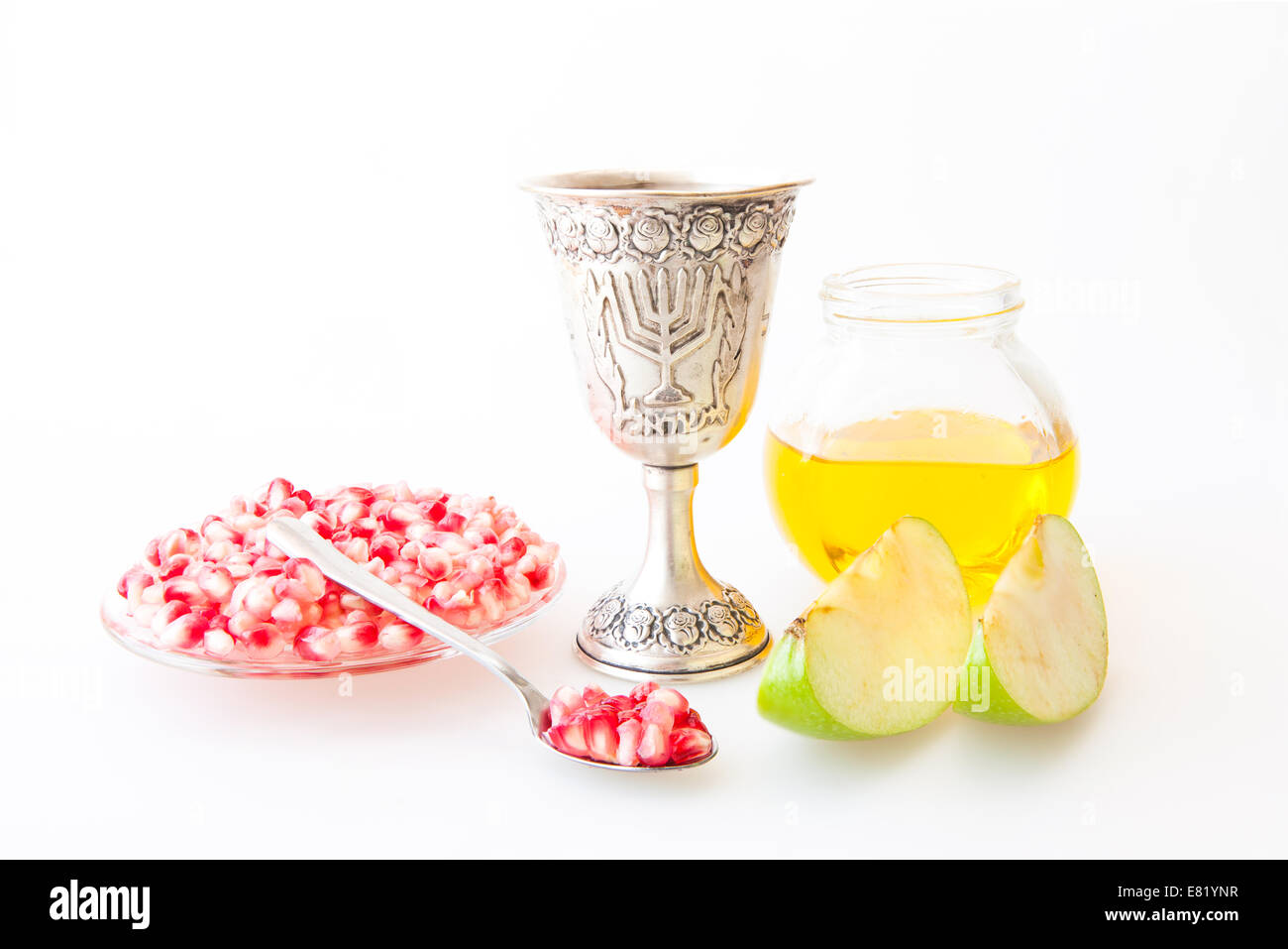 Rosh Hashanah Kiddush cup honey pomegranate and sliced apple Stock