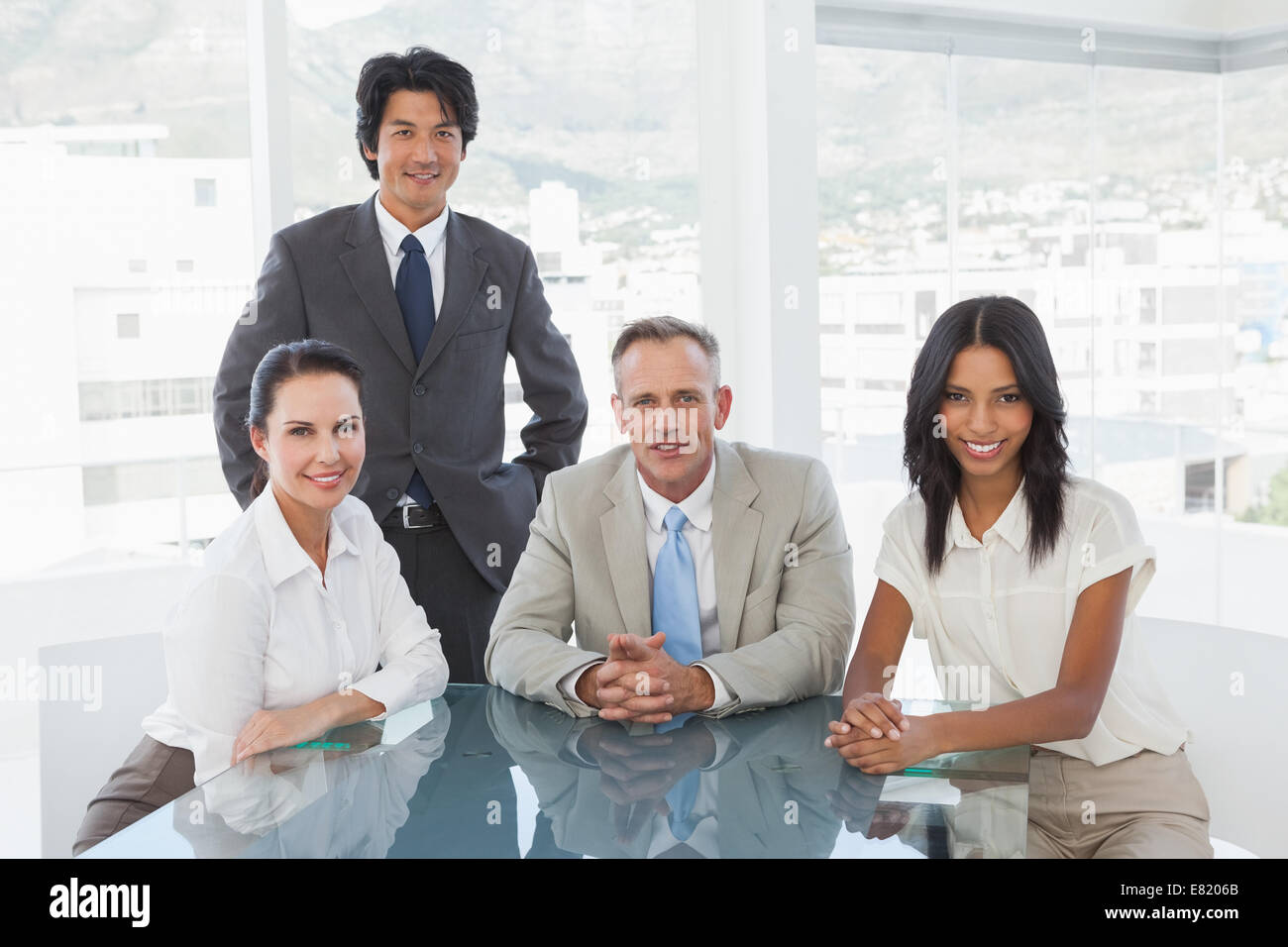 Smiling business team in an office Stock Photo - Alamy