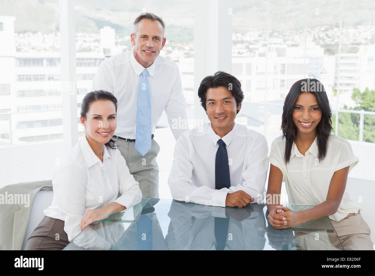 Smiling business team in an office Stock Photo - Alamy