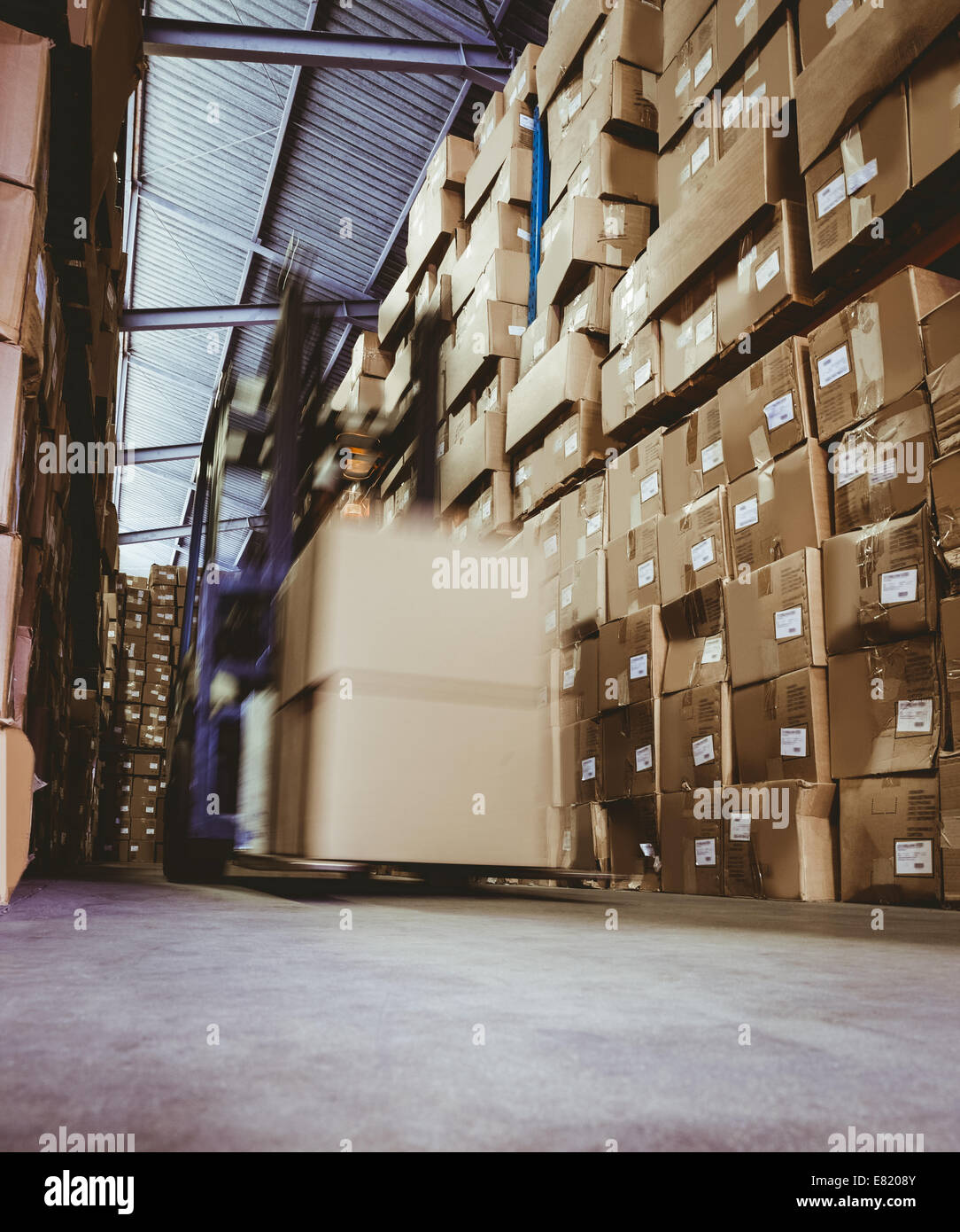 Forklift in large warehouse Stock Photo - Alamy