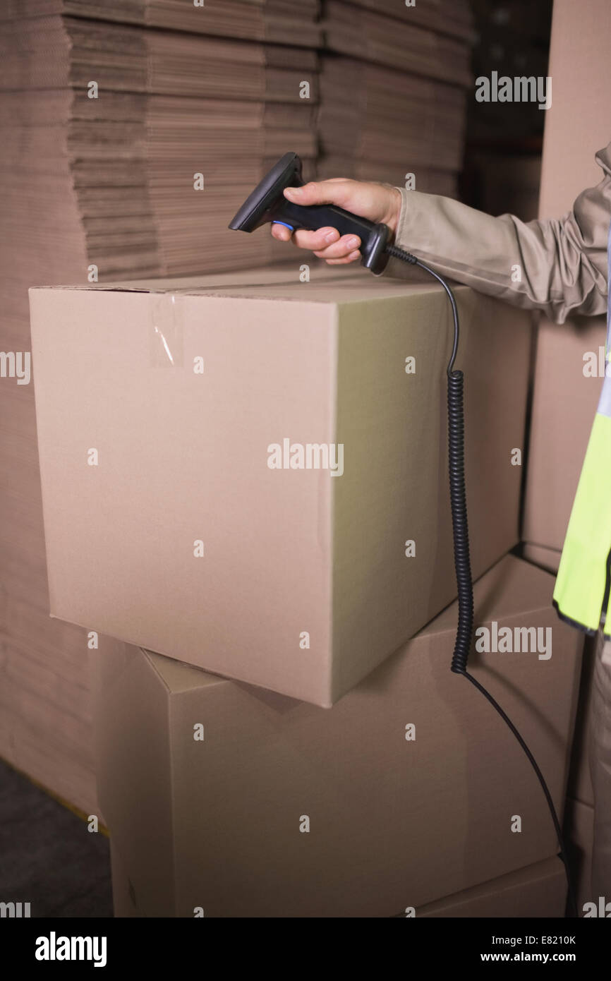 Worker using scanner in warehouse Stock Photo