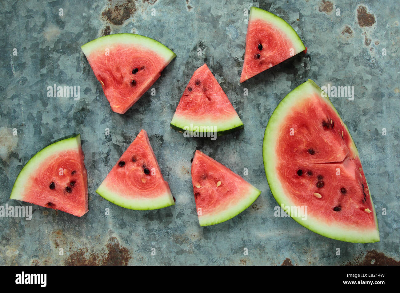 Fresh watermelon sliced in triangles on old metal board Stock Photo