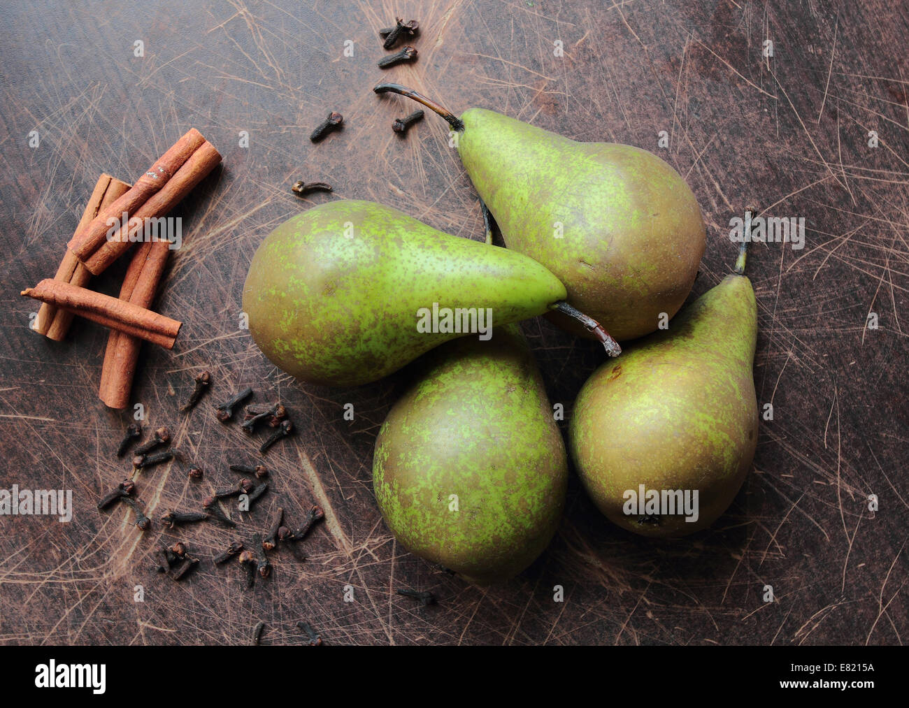 Green pears on kitchen table with aromatic spices cinnamon and clove Stock Photo