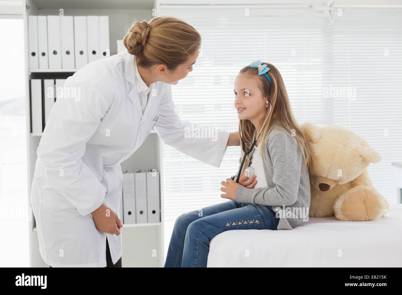 Doctor giving a patient a stuffed bear Stock Photo