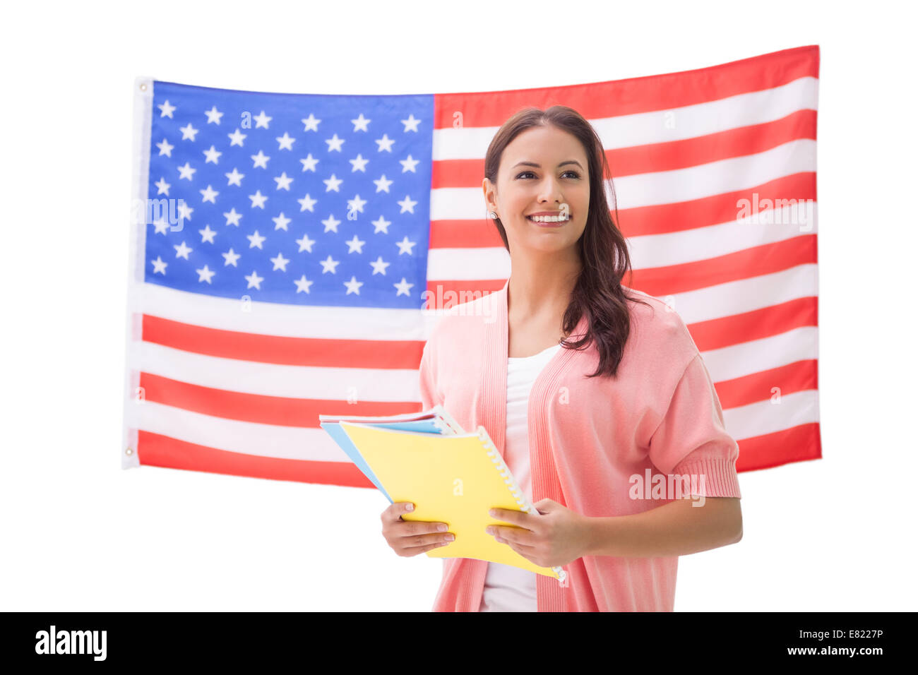 Pretty student smiling holding notebooks Stock Photo - Alamy