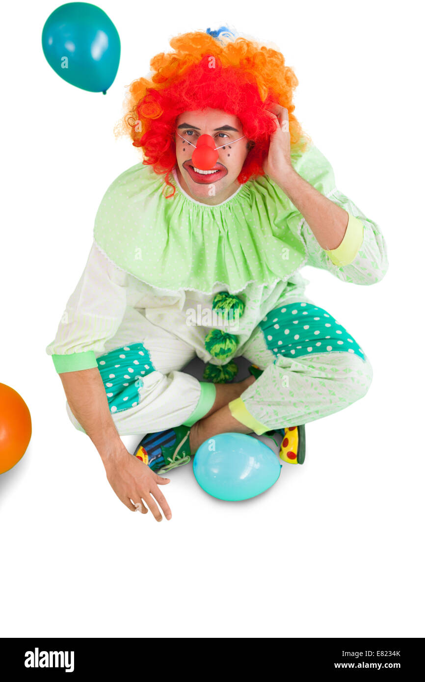 Funny clown sitting on floor Stock Photo
