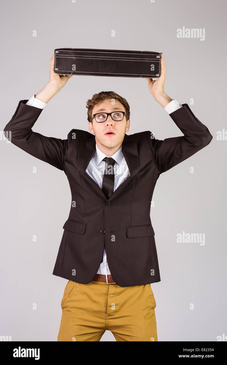 Young geeky businessman holding briefcase Stock Photo - Alamy