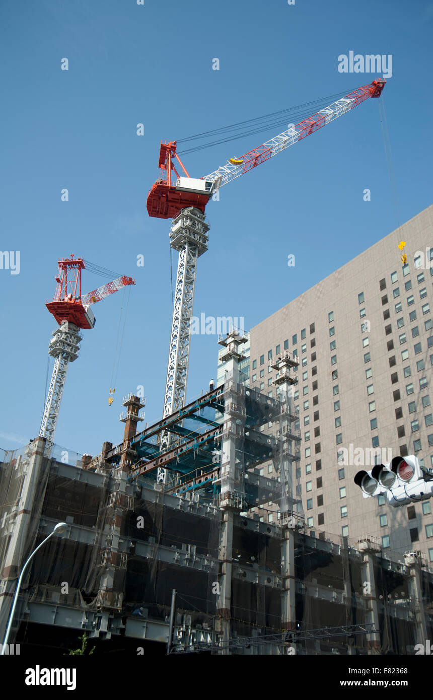 Two cranes towering above a Japanese construction site in Tokyo, Japan