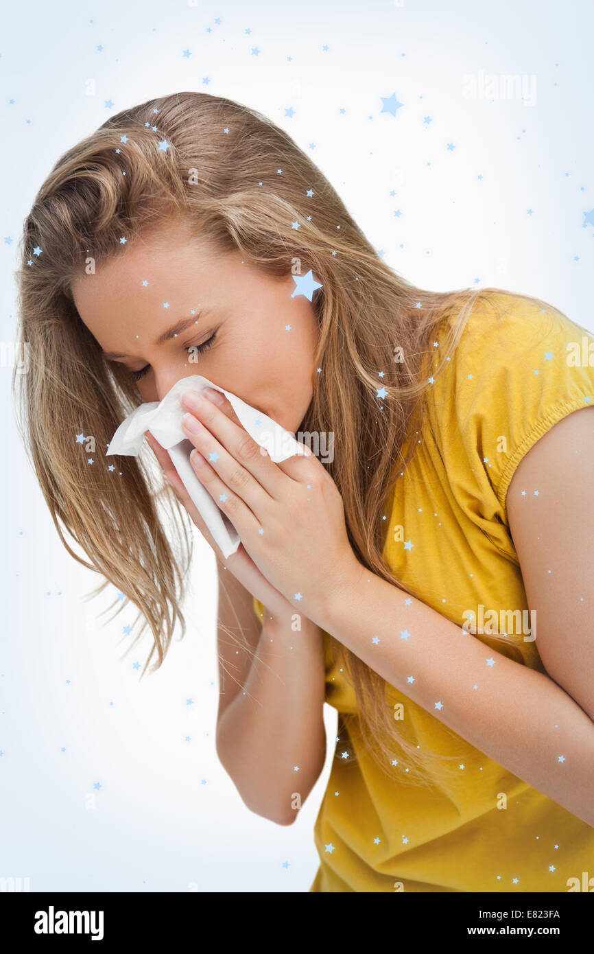 Close up of a blond young woman blowing Stock Photo - Alamy