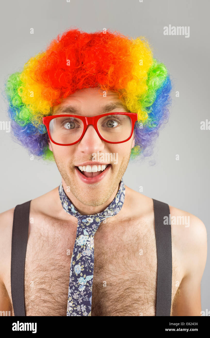Geeky hipster in afro rainbow wig Stock Photo - Alamy