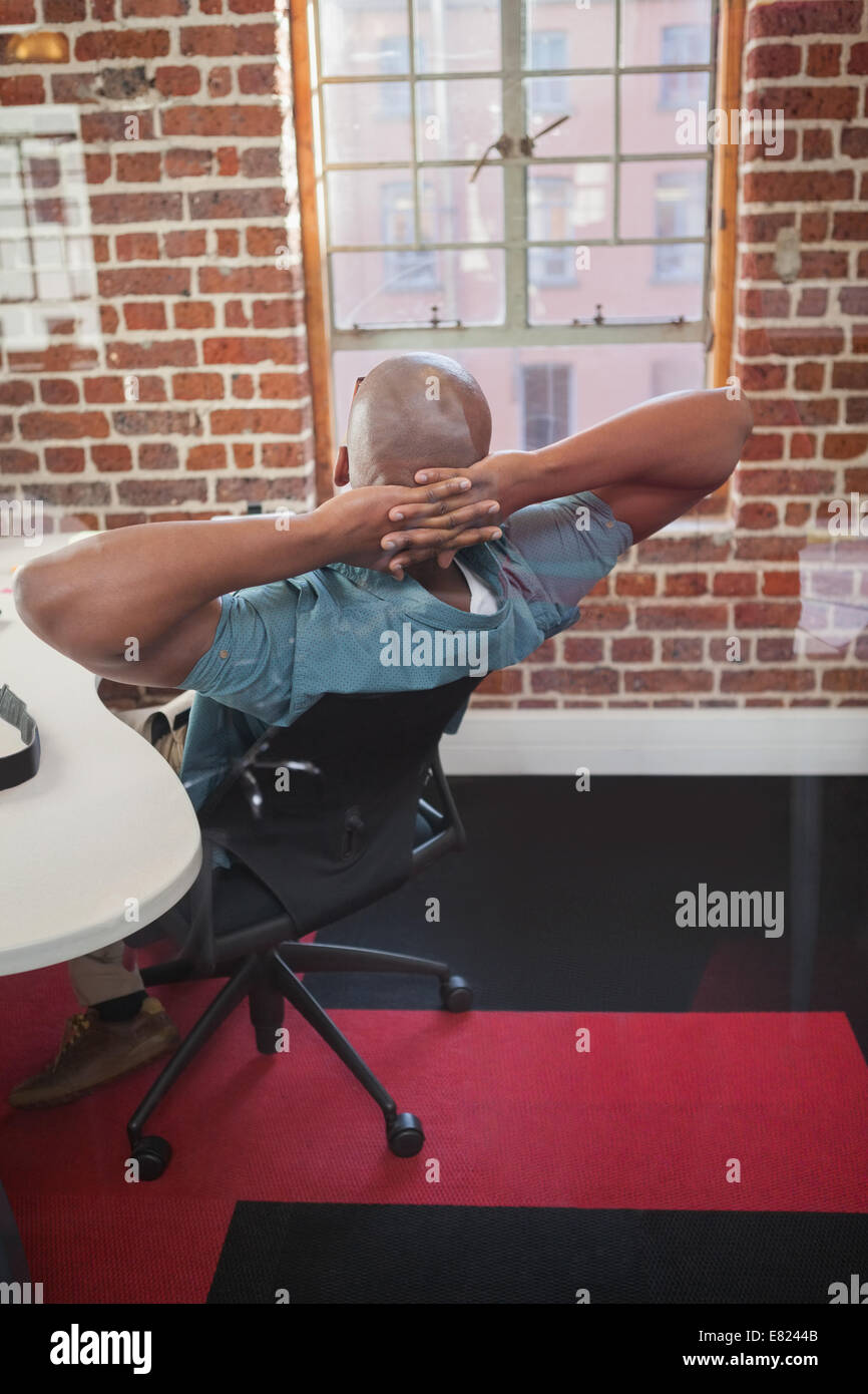Casual businessman leaning back in chair Stock Photo Alamy