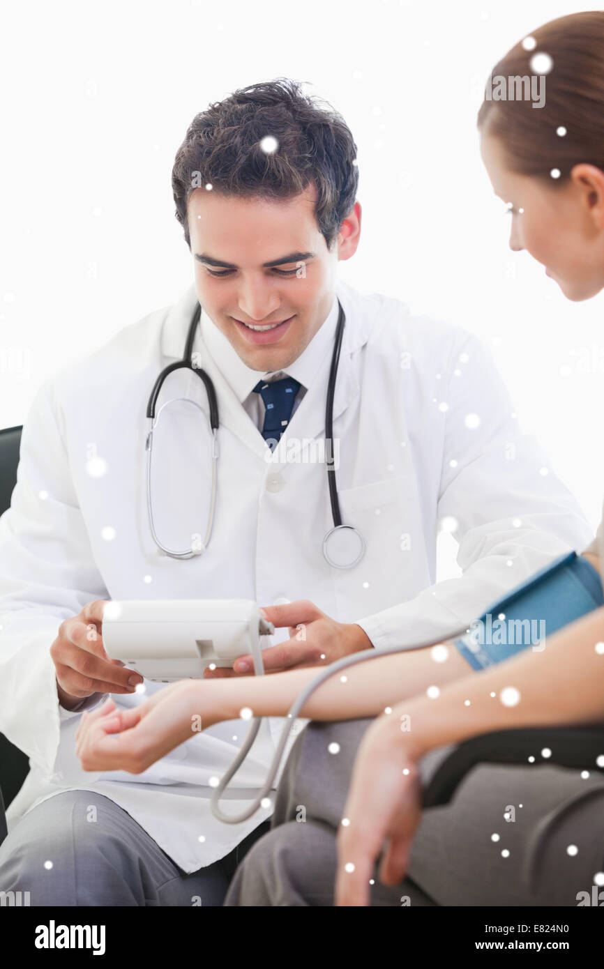 Doctor taking blood pressure of a patient Stock Photo Alamy