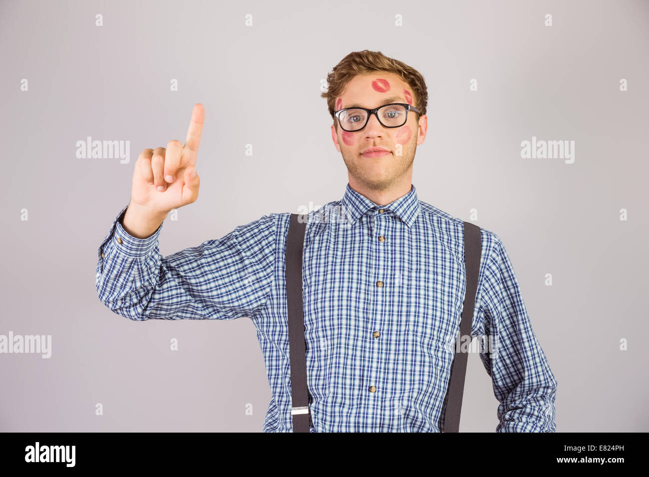 Geeky hipster covered in kisses Stock Photo