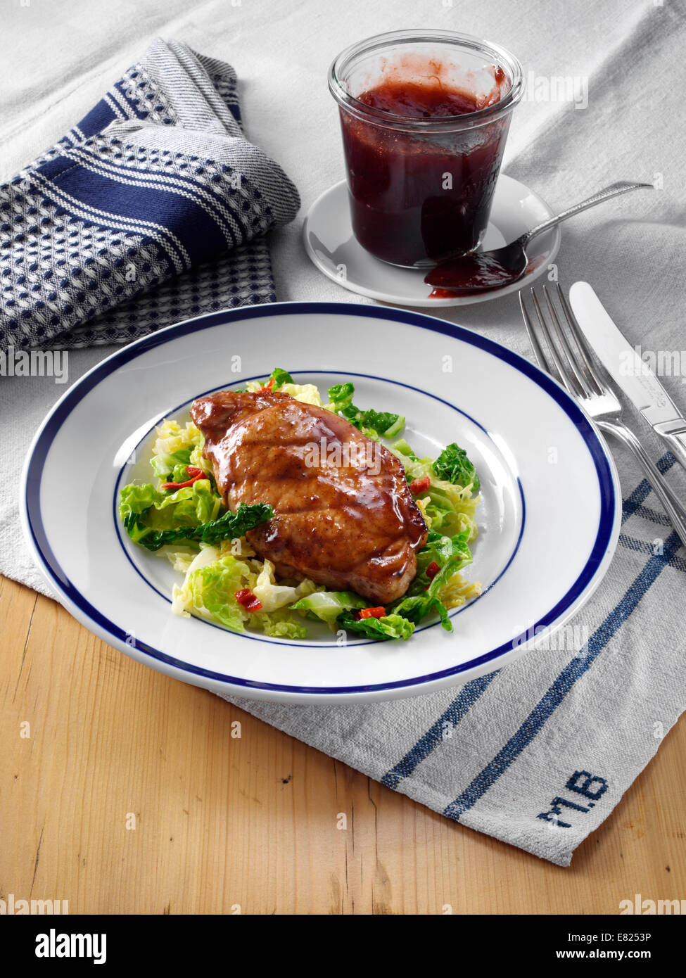 Plum glazed pork with spiced cabbage Stock Photo