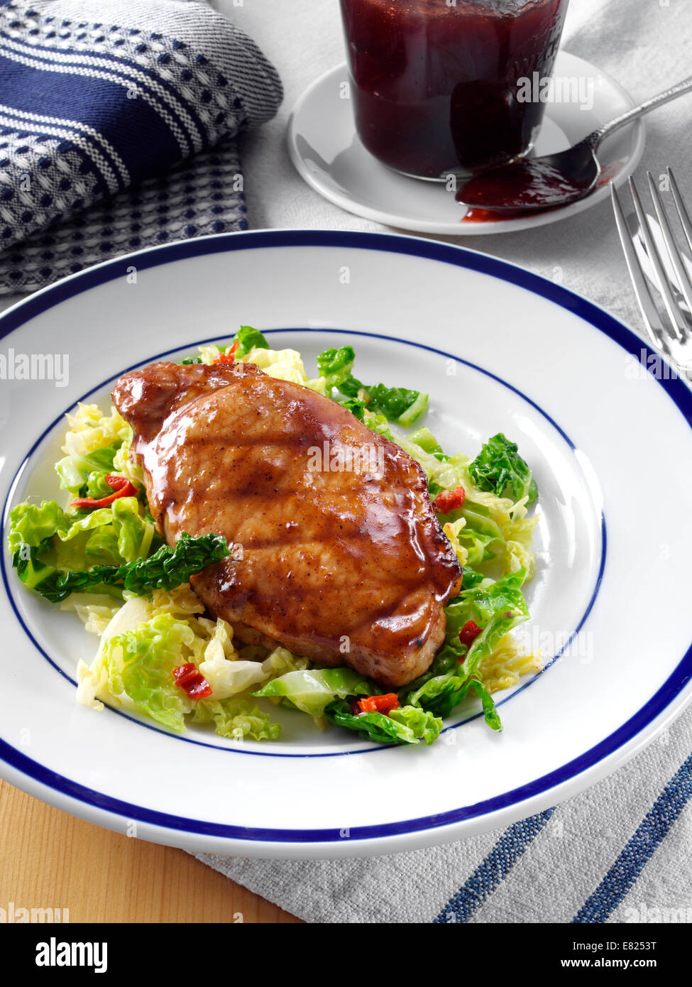 Plum glazed pork with spiced cabbage Stock Photo