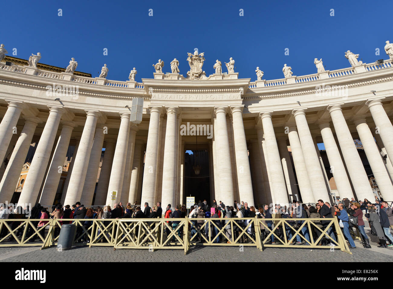 Long queue of people waiting to get into St Peter's Basilica Piazza San Pietro and Bernini's colonnade Stock Photo