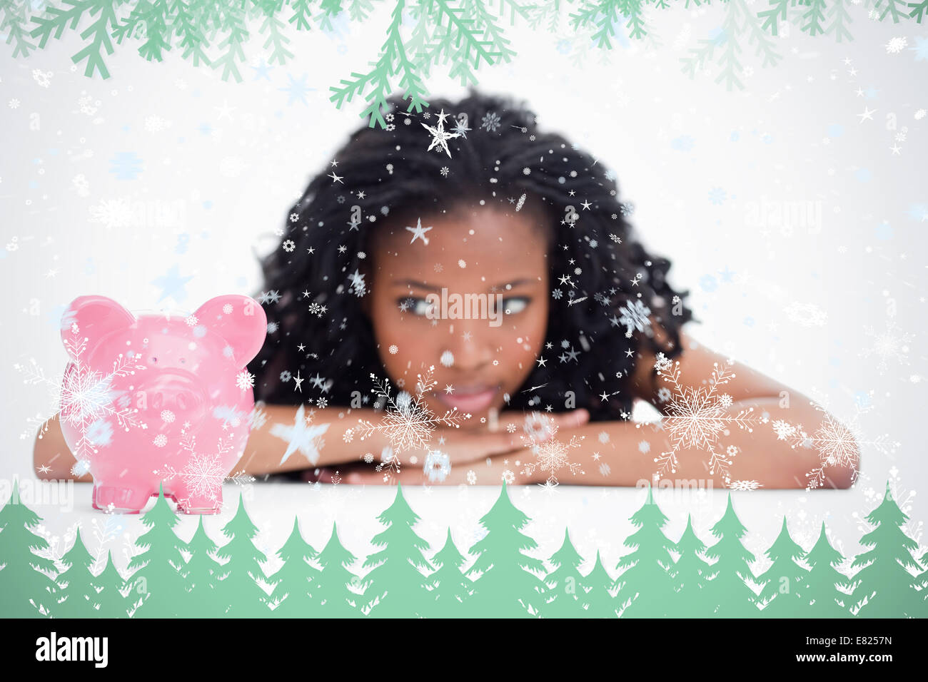 Young woman lying down resting her head on her hands is looking at a