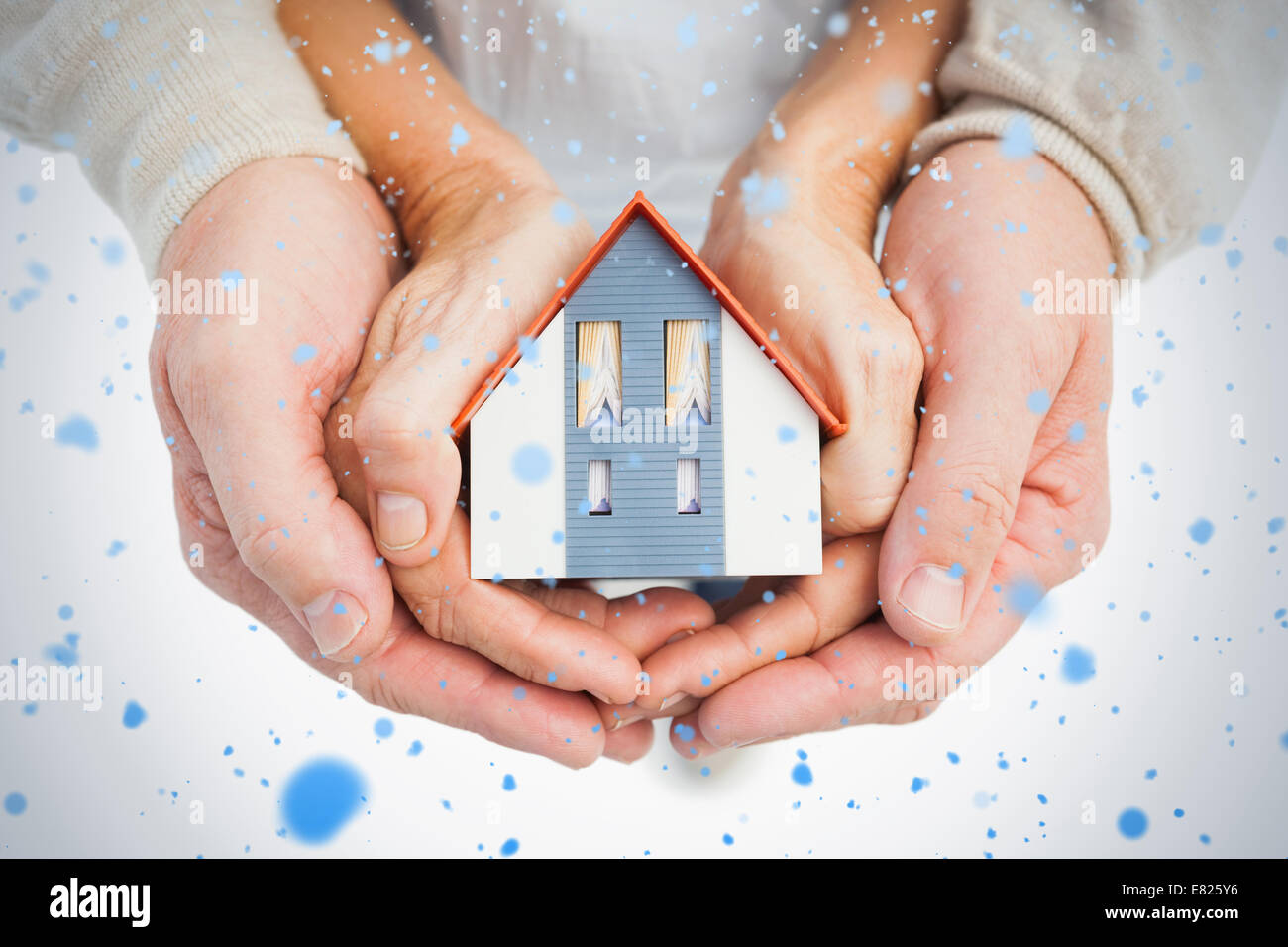 Couple holding small model house in hands Stock Photo - Alamy