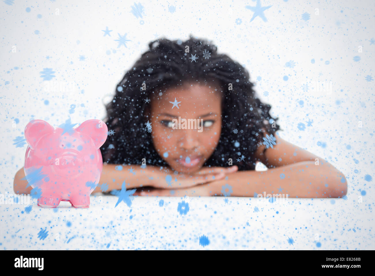 Young woman lying down resting her head on her hands is looking at a