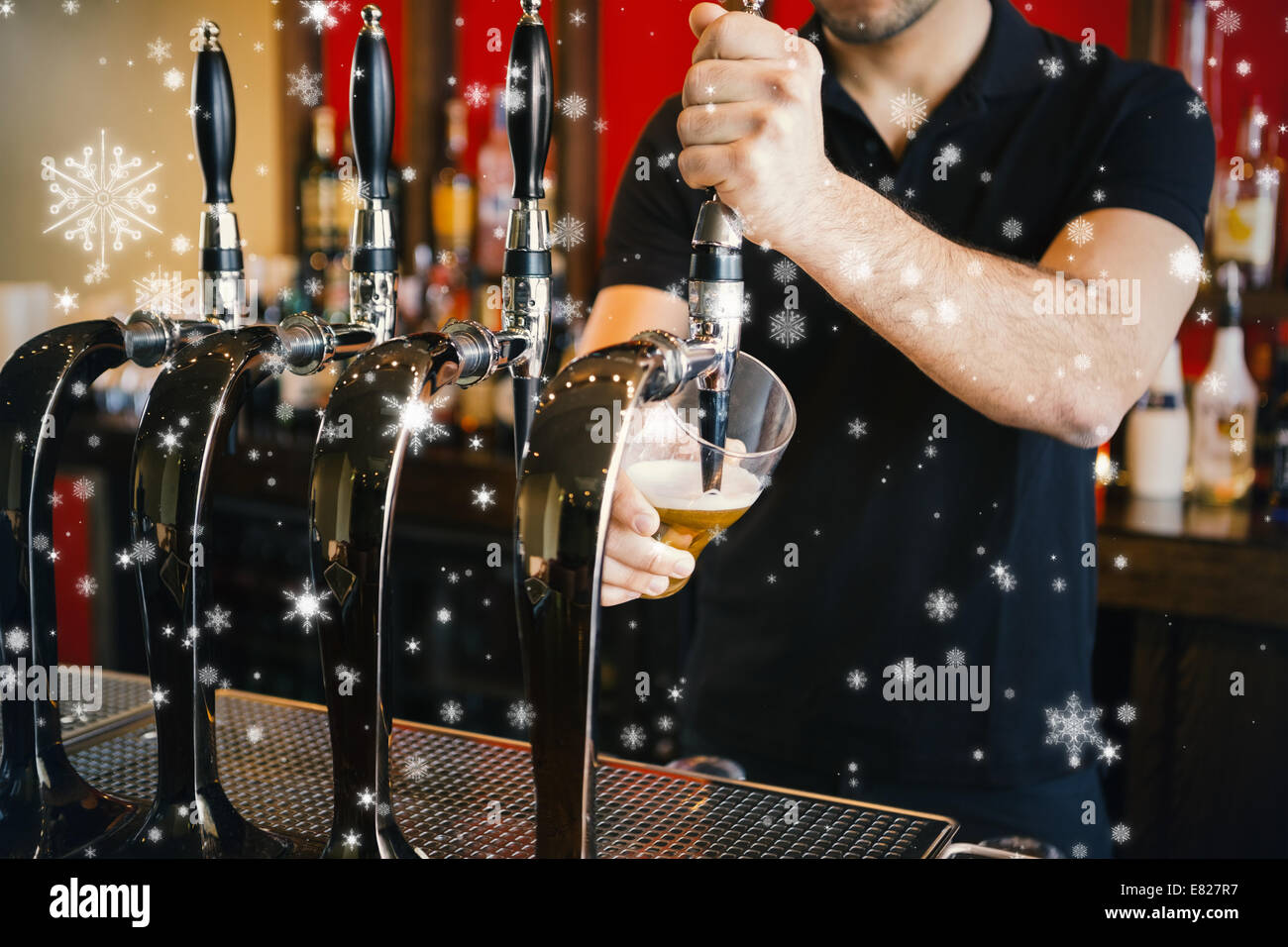 Composite image of barkeeper pulling a pint of beer Stock Photo
