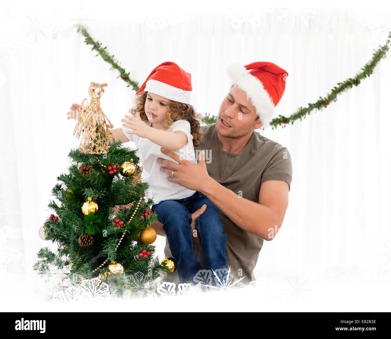 Cute daughter decorating the christmas tree with his father Stock Photo ...