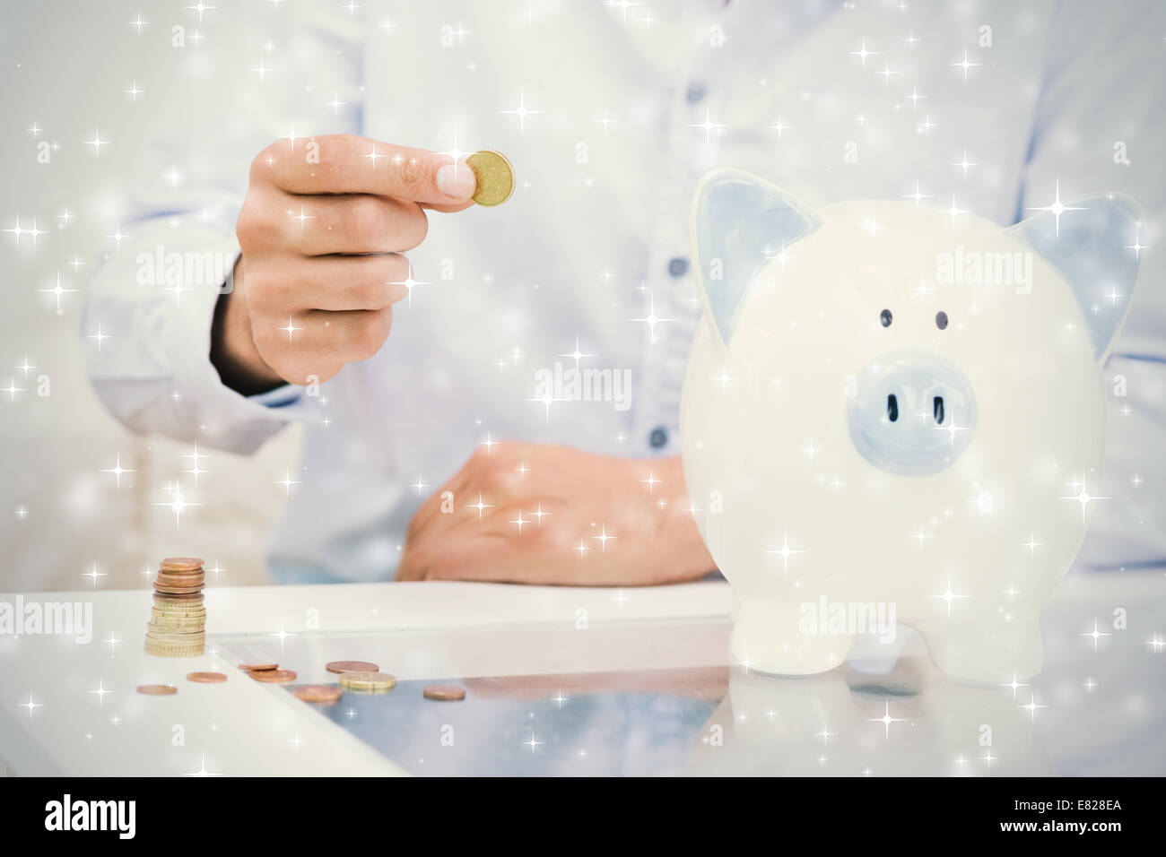 Mid section of a man putting some coins into a piggy bank Stock Photo ...