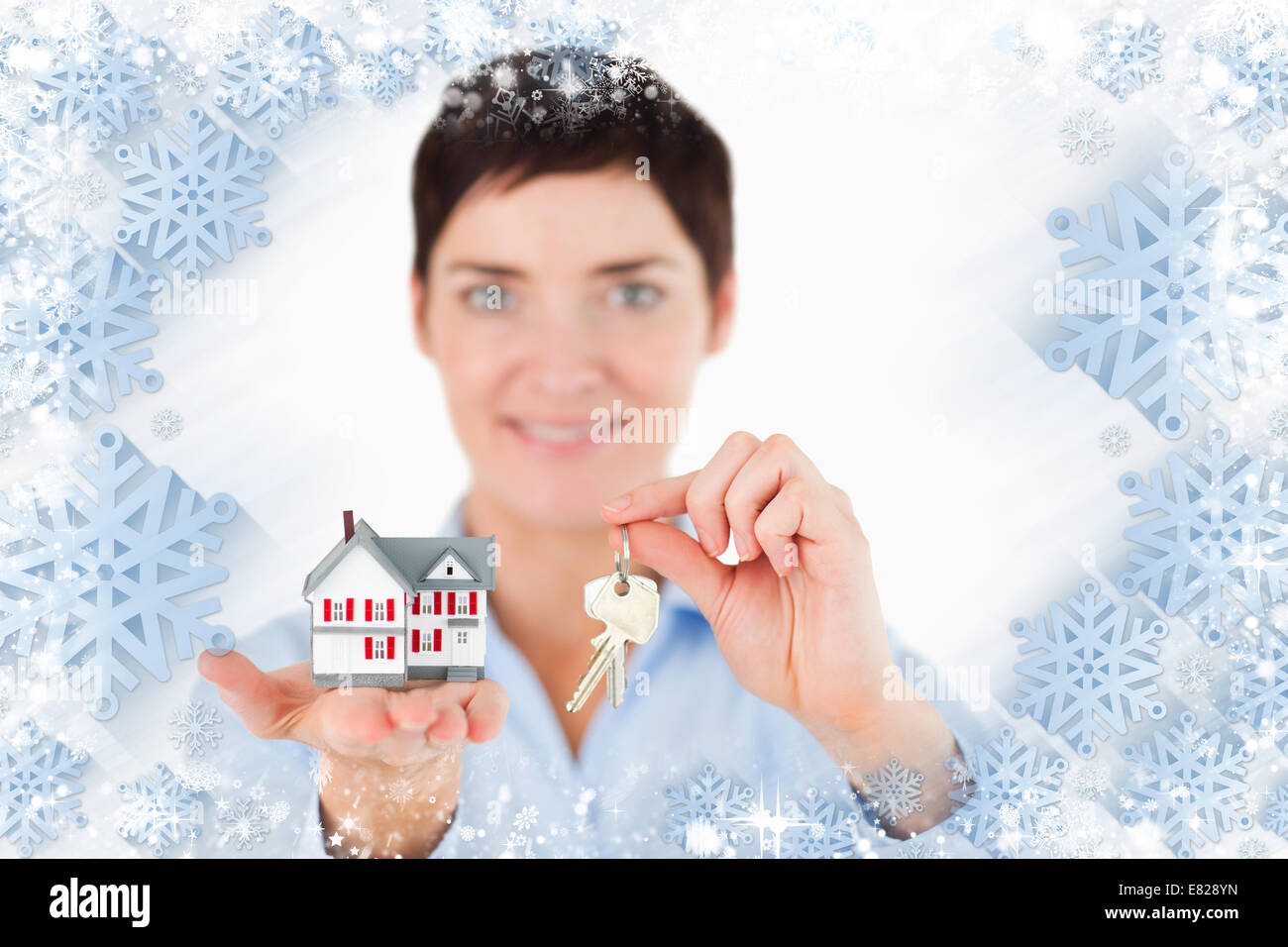 Close up of a woman showing keys and a miniature house Stock Photo - Alamy
